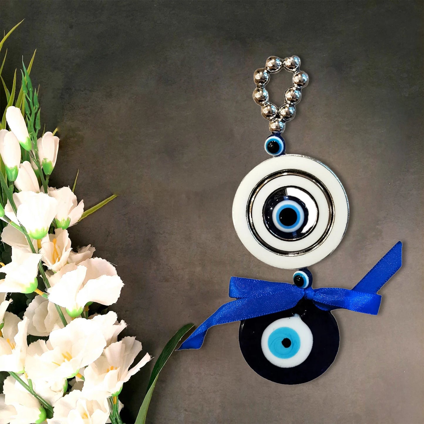 Evil Eye Amulet with 4 Eyes hanging at home entrance for protection from bad luck