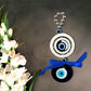 Evil Eye Amulet with 4 Eyes hanging at home entrance for protection from bad luck