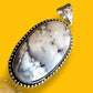 Natural White Howlite Gemstone Pendant Displayed on Rustic Surface – Crystal for Peace and Spiritual Insight

