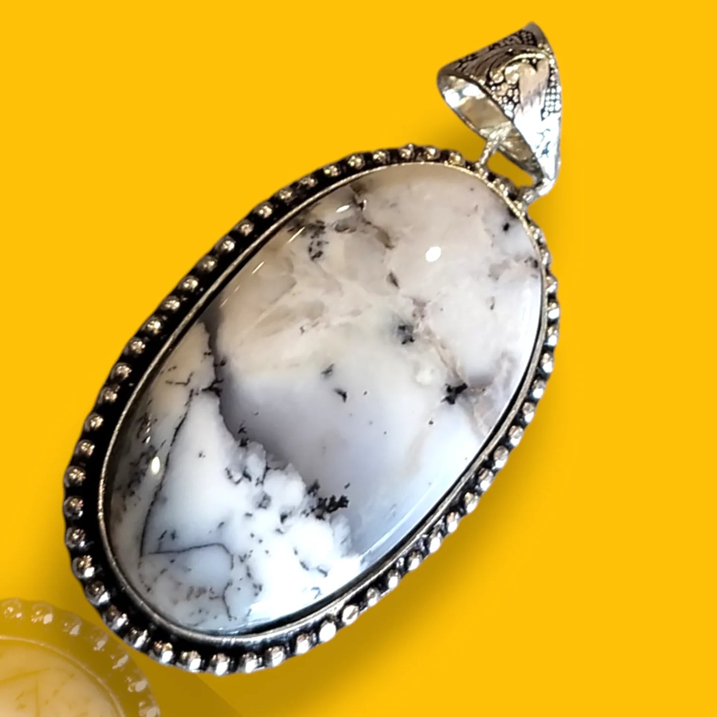 Natural White Howlite Gemstone Pendant Displayed on Rustic Surface – Crystal for Peace and Spiritual Insight


