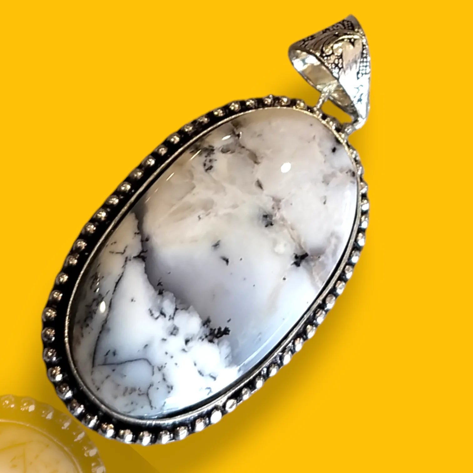 Natural White Howlite Gemstone Pendant Displayed on Rustic Surface – Crystal for Peace and Spiritual Insight

