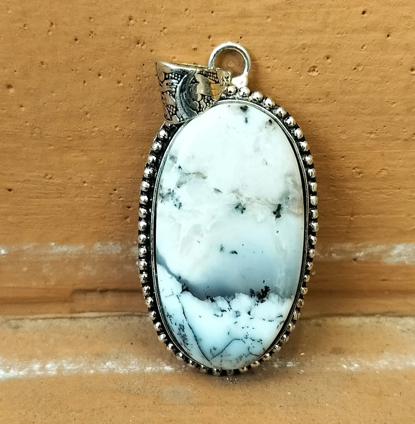 Hand Holding White Howlite Pendant – Healing Stone Jewelry for Anxiety, Sleep, and Creative Focus