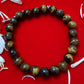 A detailed view of Tiger Eye gemstone, exhibiting its shimmering golden-brown stripes, associated with courage, strength, and protection.