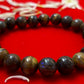  Image of a person wearing a Tiger Eye Reiki healing bracelet, emphasizing its grounding and protective qualities.